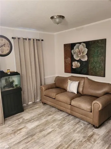 Living room with wood finished floors and a textured ceiling