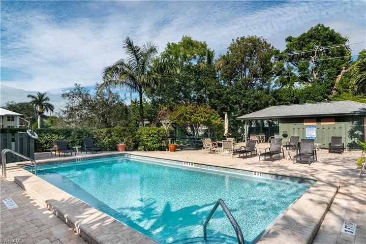 Community pool with a patio