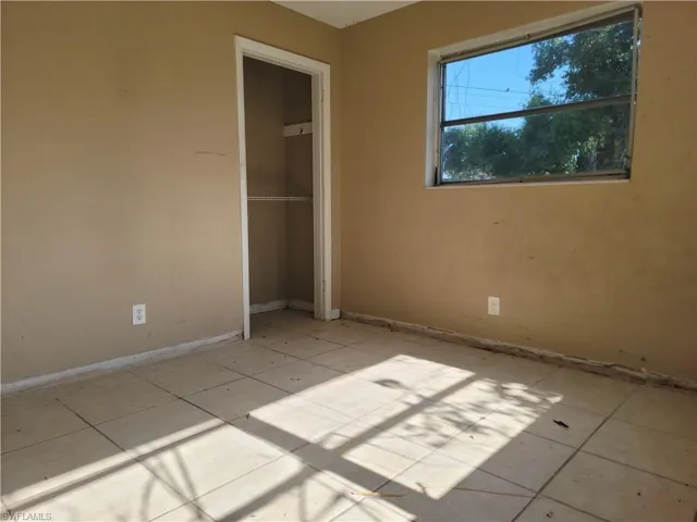 Unfurnished bedroom with a closet and baseboards