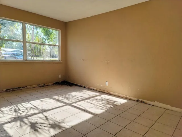 Empty room featuring light tile patterned floors