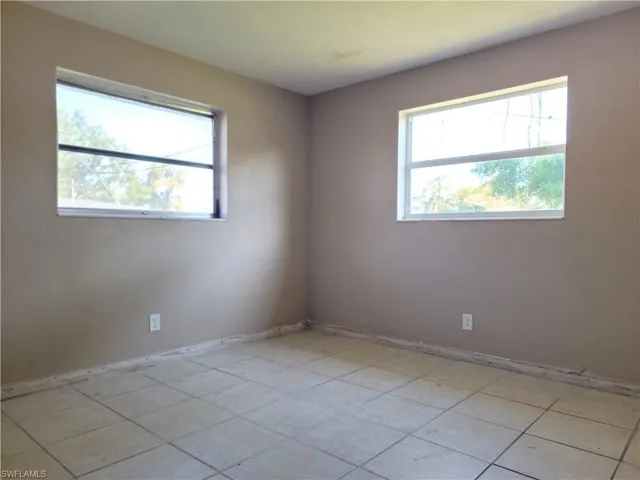 Spare room featuring baseboards