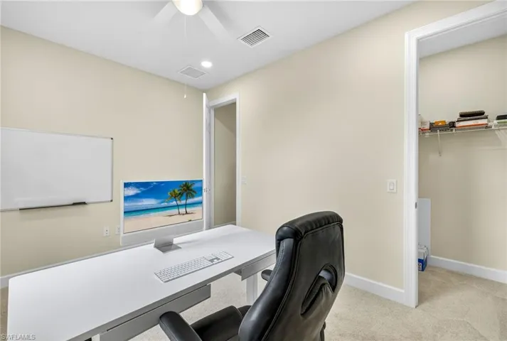 Carpeted office featuring ceiling fan, attic access, and recessed lighting