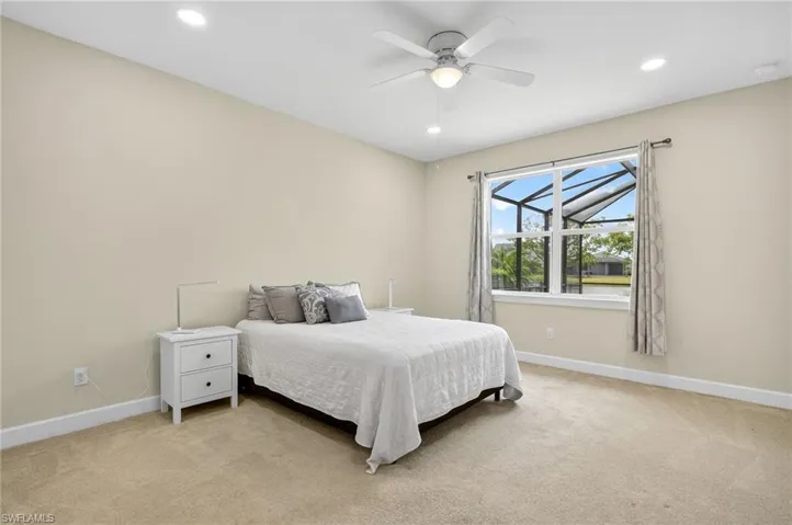 Bedroom featuring light colored carpet, recessed lighting, and ceiling fan