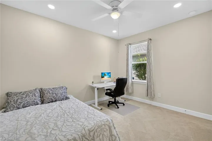 Bedroom with carpet floors, recessed lighting, a desk, and a ceiling fan