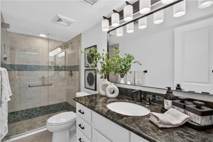 Guest bathroom with walk-in shower, glass shower doors.
