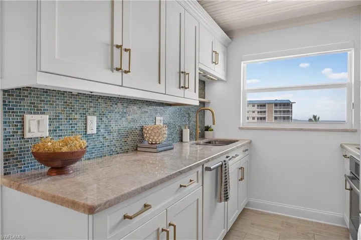 Quartz counters, mocha cabinetry, and new cabinet hardware.