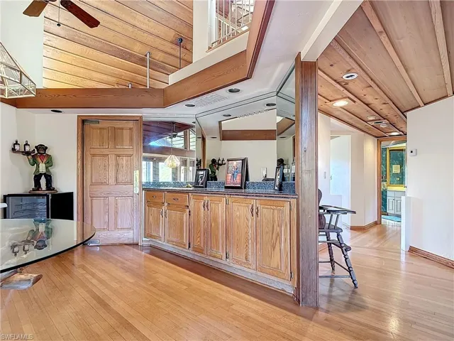 Kitchen with dark countertops, lofted ceiling, light wood-style floors, ceiling fan, and wooden ceiling
