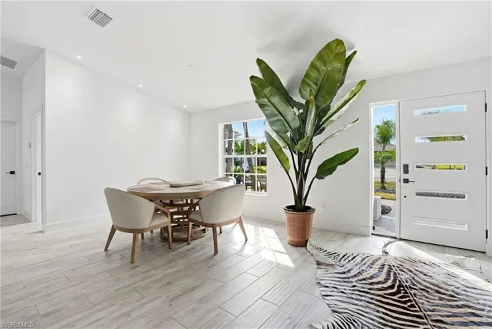 Dining room featuring light wood-style flooring and recessed lighting