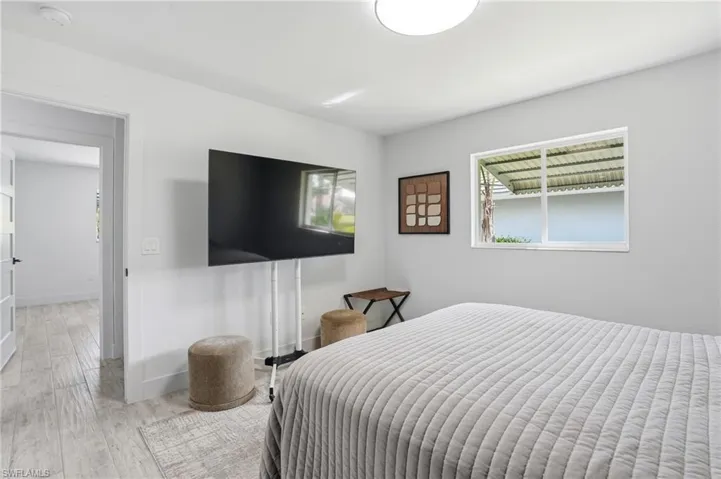 Bedroom featuring light wood-style floors and baseboards