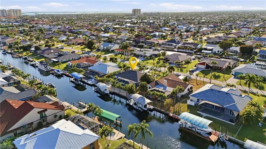View of property location with a nearby body of water and nearby suburban area