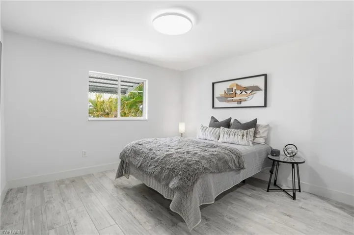 Bedroom with light wood-style floors and baseboards