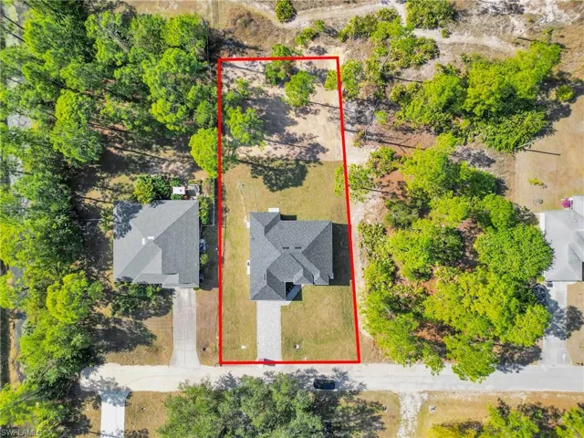 Aerial view of property and surrounding area featuring property parcel outlined