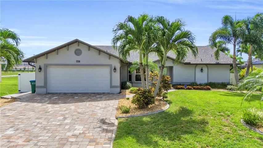 Ranch-style house with a garage and a front yard