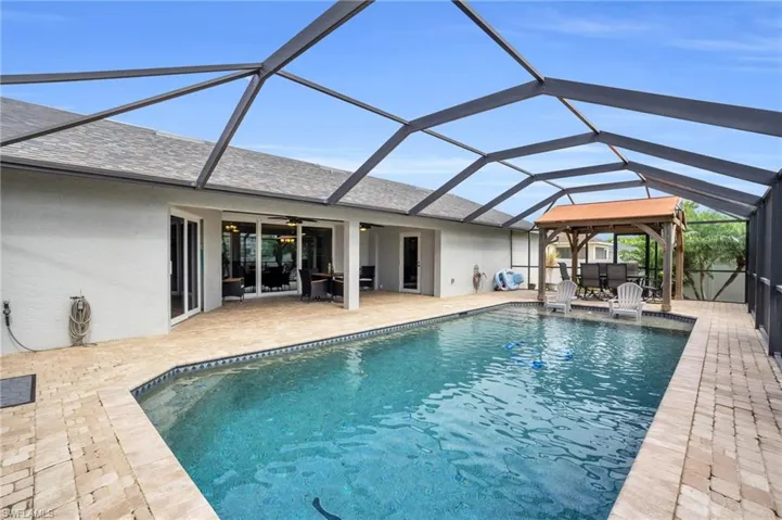 View of swimming pool with a lanai and a patio