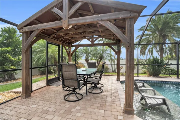 View of patio with a gazebo and a lanai