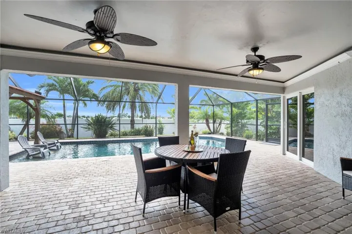 Sunroom / solarium featuring ceiling fan
