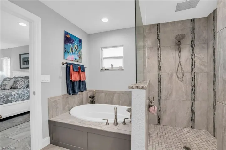 Bathroom with plus walk in shower and tile patterned floors