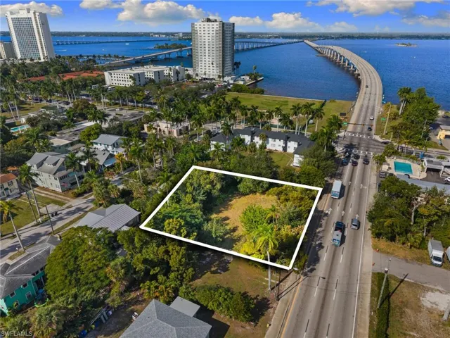 Aerial view of property and surrounding area with a notable bridge, a large body of water, and property boundaries highlighted