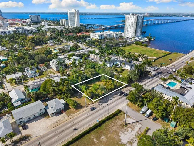 View of urban area with a notable bridge, property parcel outlined, and a nearby body of water