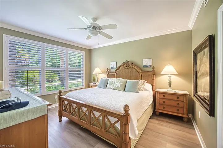 Bedroom featuring ornamental molding, ceiling fan, and hardwood / wood-style floors