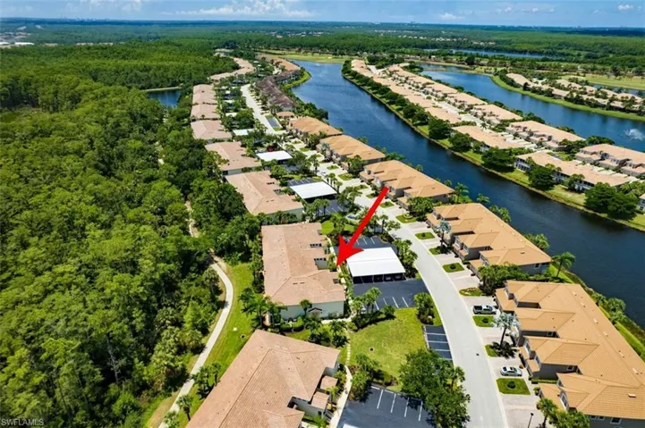 Birds eye view of property with a water view