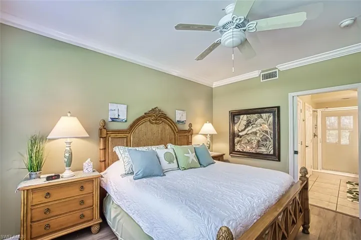 Bedroom featuring ornamental molding, ceiling fan, and dark wood-type flooring