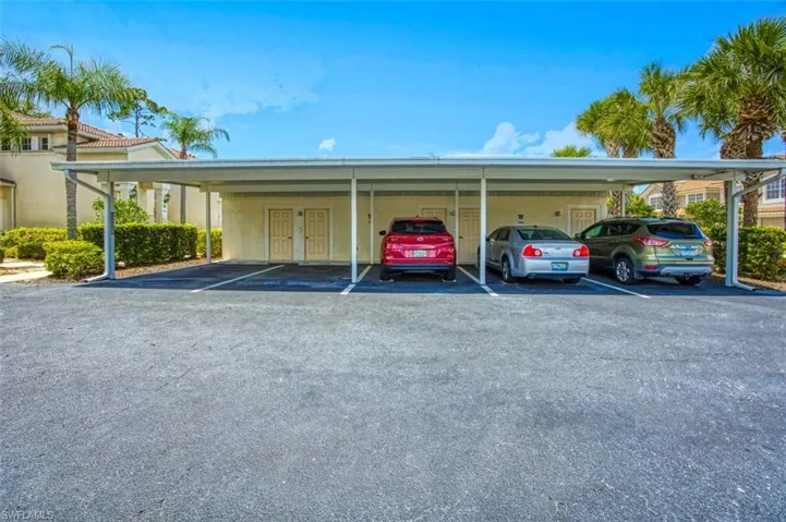 View of parking featuring a carport