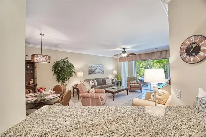 Living room with crown molding and ceiling fan