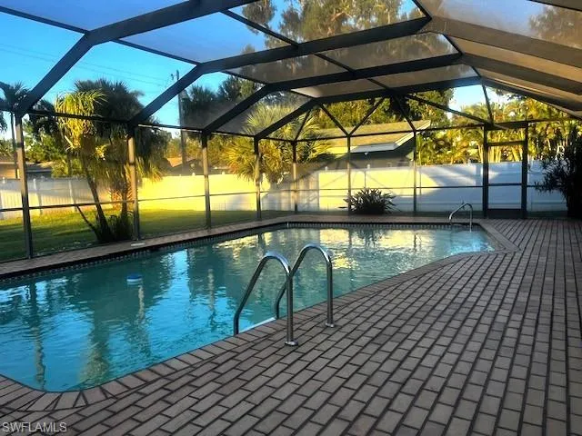 View of pool with a lanai and a sunroom