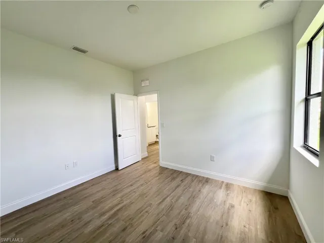 Spare room with wood-type flooring