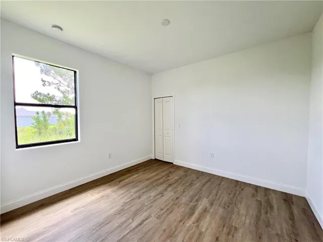 Empty room featuring wood-type flooring