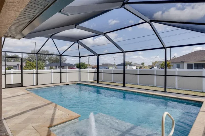 View of swimming pool with a fenced backyard, glass enclosure, a sunroom, and a residential view