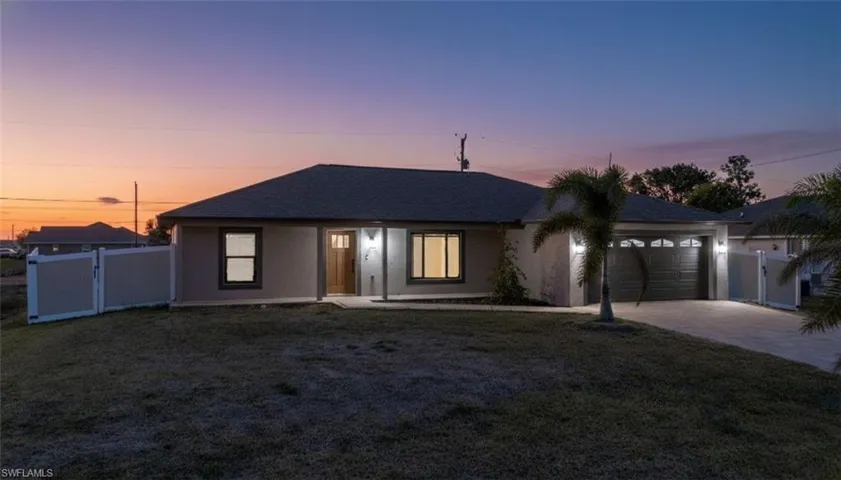 Ranch-style home with a gate, a garage, concrete driveway, and a shingled roof