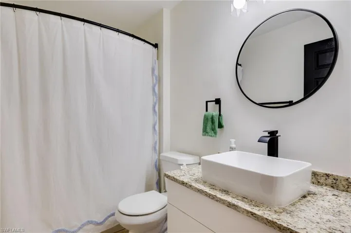 Bathroom featuring vanity and a shower with shower curtain