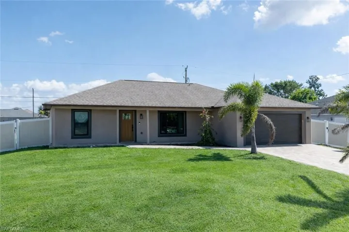 Single story home with a gate, a garage, driveway, and roof with shingles