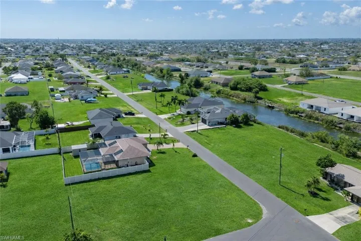 Aerial perspective of suburban area with a nearby body of water