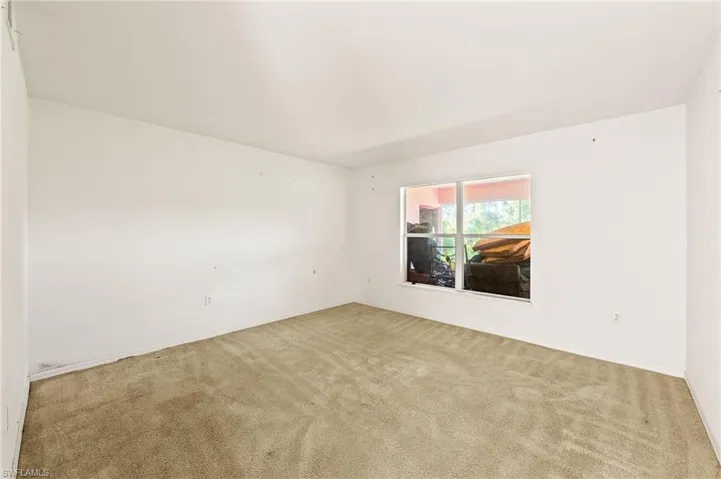Carpeted spare room with baseboards