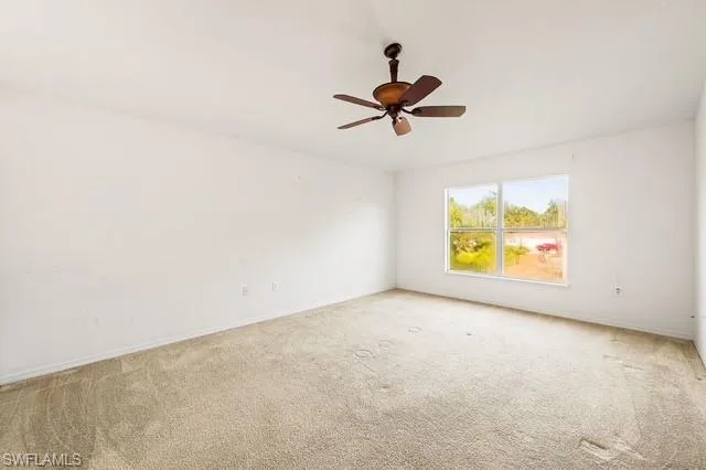 Unfurnished room with light carpet and ceiling fan