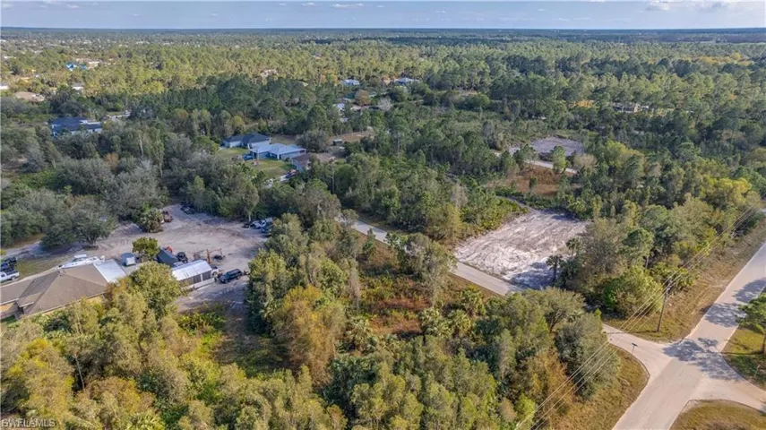 View of property location featuring a forest