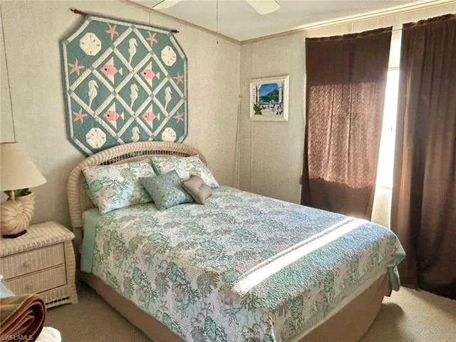 Carpeted bedroom with crown molding