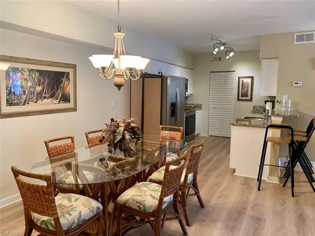 Dining area with light wood-style flooring and a chandelier