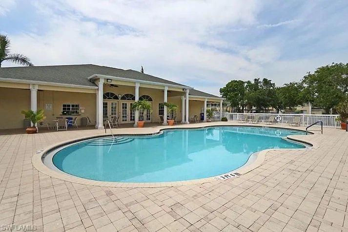 Community pool with a patio area, french doors, and ceiling fan