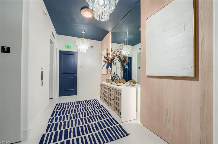 Mudroom with a chandelier and tile patterned floors