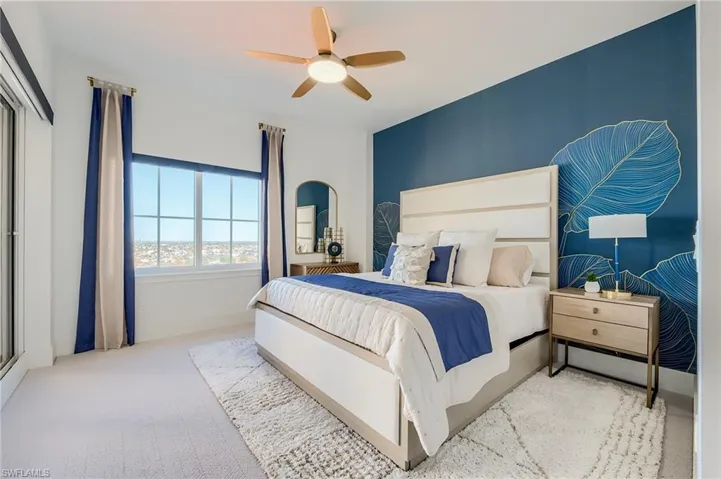 Bedroom with ceiling fan and carpet
