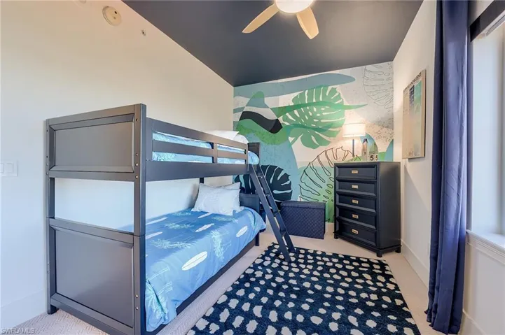Carpeted bedroom with ceiling fan