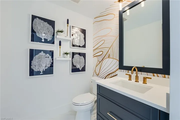 Half bath featuring vanity and toilet