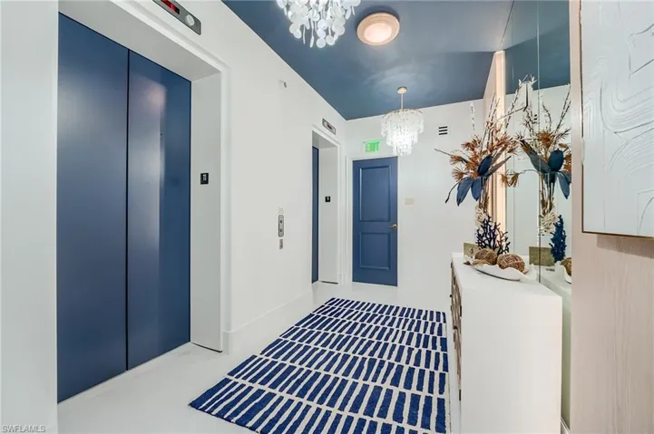 Entryway featuring a chandelier and elevator
