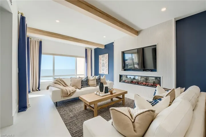 Living room featuring beam ceiling and recessed lighting