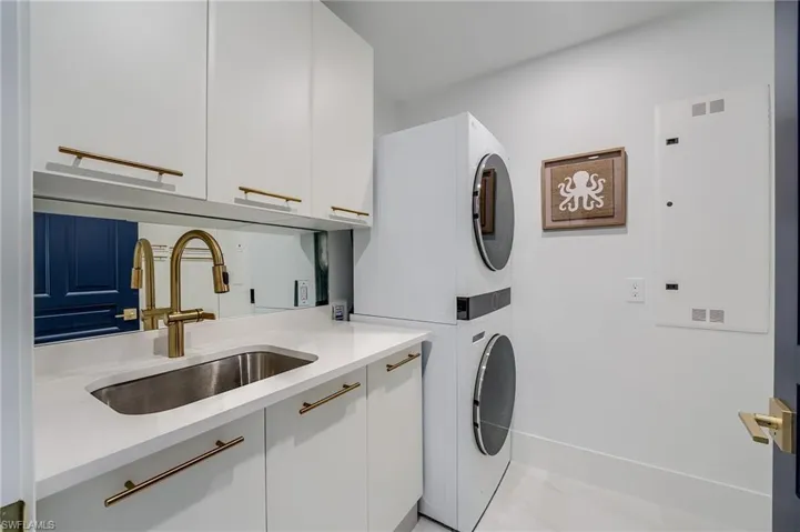 Washroom with estacked washer and dryer and cabinet space