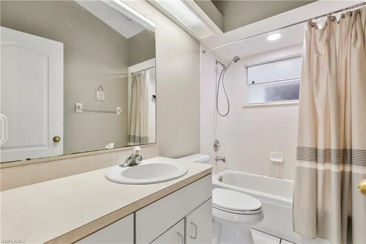 Full bathroom with vanity, tile patterned flooring, toilet, and shower / bath combination with curtain